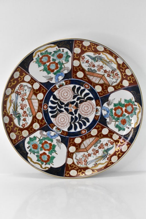 Antique Japanese Porcelain Imari Phoenix Charger: Piece is in excellent condition; on the underside there is a white, chalk-like material stuck to the edge that can chip away; however, it is not actual damage. Approx. dimensions Dia: 18".