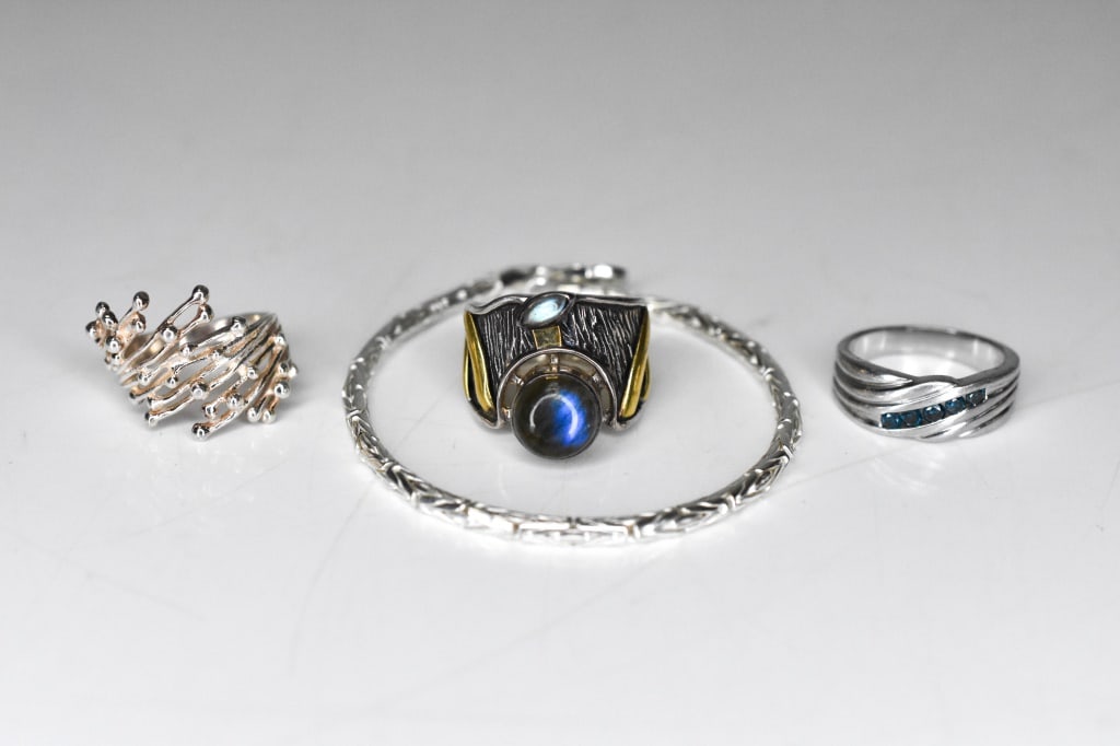 Sterling Modernist Cosmic Wrap & Labradorite Ring: 1 Sterling silver modernist cosmic wrap ring. 1 modernist sterling silver and bark textured ring with 2 labradorite stones. 1 sterling silver sapphire colored ring. 1 sterling silver Byzantine link br