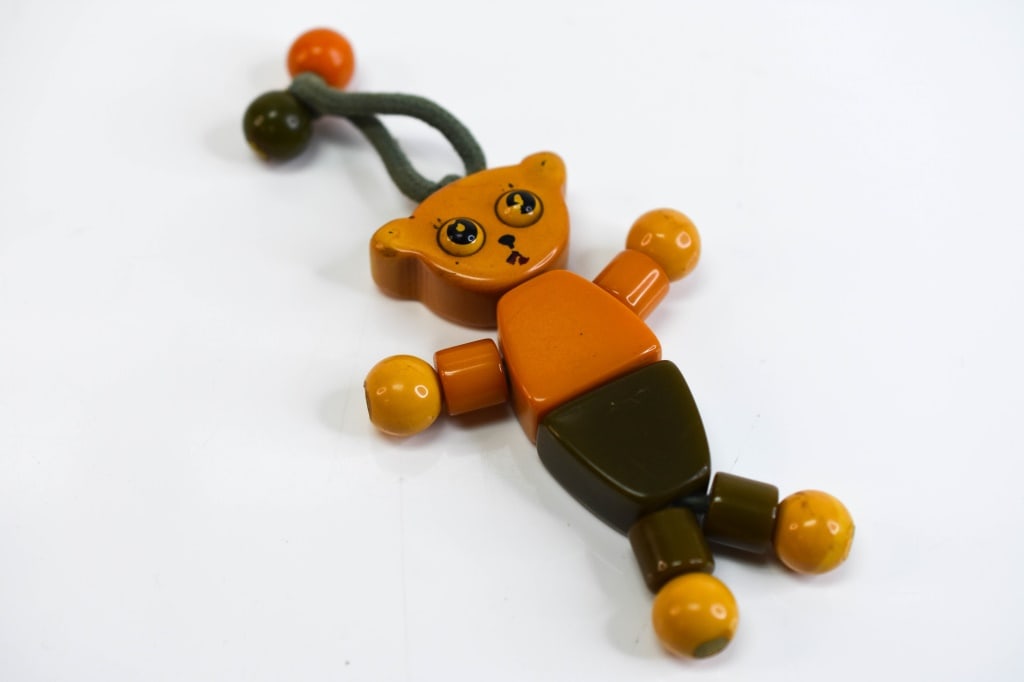 Vintage Bakelite Tykie Toy Jewelry: Tykie crib toy bear is in good condition, shows some wear from age and use.Measures approx. 3.36"h (just bear), approx. 5"h with beads.