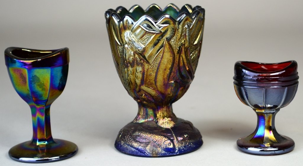 Lot of 3 Carnival Glass Lot Eye Wash, Egg Cup: Boyd eyewash, amethyst 2.5" h, eyewash red 2" h, eggcup storks and fish pattern, blue, 3.25" h