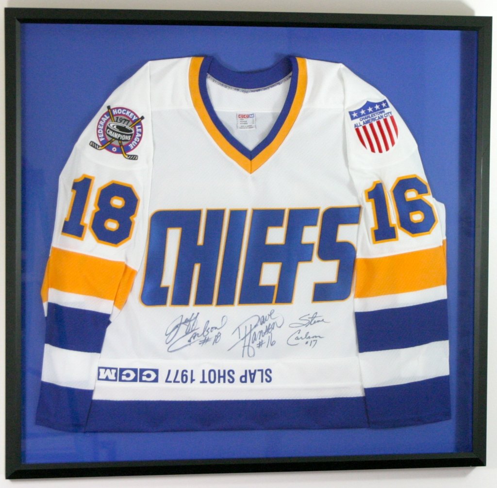 Slapshot movie signed jersey: Signed by Jeff Carlson #18, Dave Hanson #16, Steve Carlson #17. Framed 34"W x 32" H