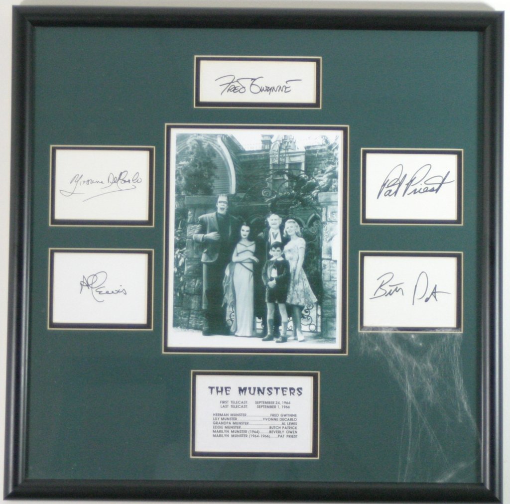 The Munsters Cast photo With Autographs: Beautifully framed and matted photo with signed autograph cards by Fred Gwynne, Yvonne Decarlo, Al Lewis, Butch Patrick, and Pat Priest. 22"W x 22"H. No COA