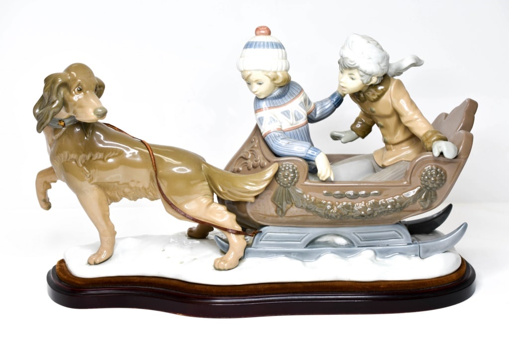 Lladro "Sleigh Ride": Lladro "Sleigh Ride,"#5307, K2M, approx. 18" long. There appear to be no visible chips, cracks, breaks, to the porcelain; there is loss to the leather leash on one side that has worn away due to age; 
