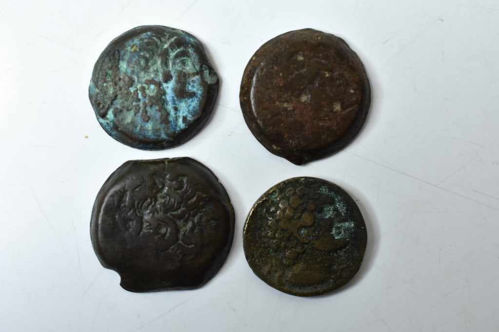 Ptolemy and Ancient Bronze Coins: Collection of ancient Ptolemy, Follis, or Roman coins, with depictions of Zeus on the fronts and various Eagles on the reverses. Provenance: directly from a consignor / inheritance of a private collec