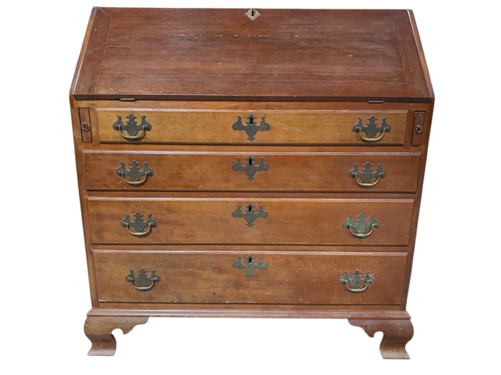 Antique Chippendale Secretary Desk Circa 1800: Slant-front secretary desk crafted from wood featuring four drawers with brass hardware and a hinged front panel that opens to reveal a compartmented interior with small drawers and an inlaid central 