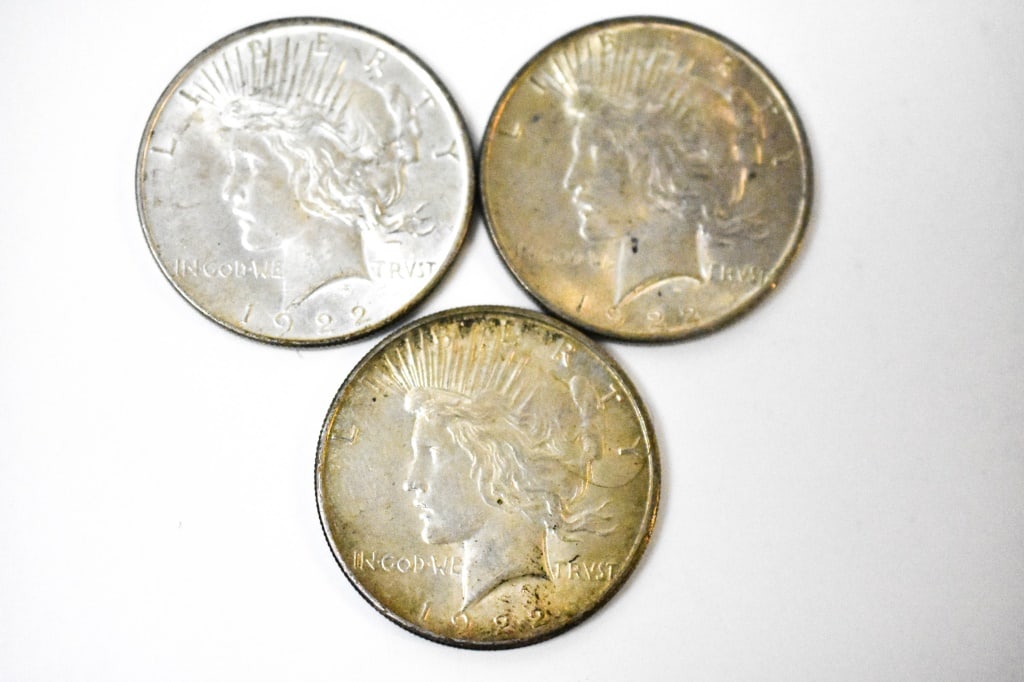 1922 Silver Peace Dollars: Includes (3) silver peace dollars; some toning on some of them. 2 are from Philadelphia, 1 from San Francisco. They can have nicks and scratches.