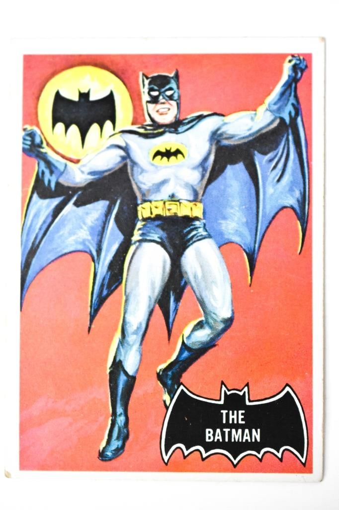 1966 Topps Black Bat Batman #1: Considered to be batman's rookie card. Centering is off. Corners show wear. Above the right wing of the black bat is a faint crease. Edge wear through out