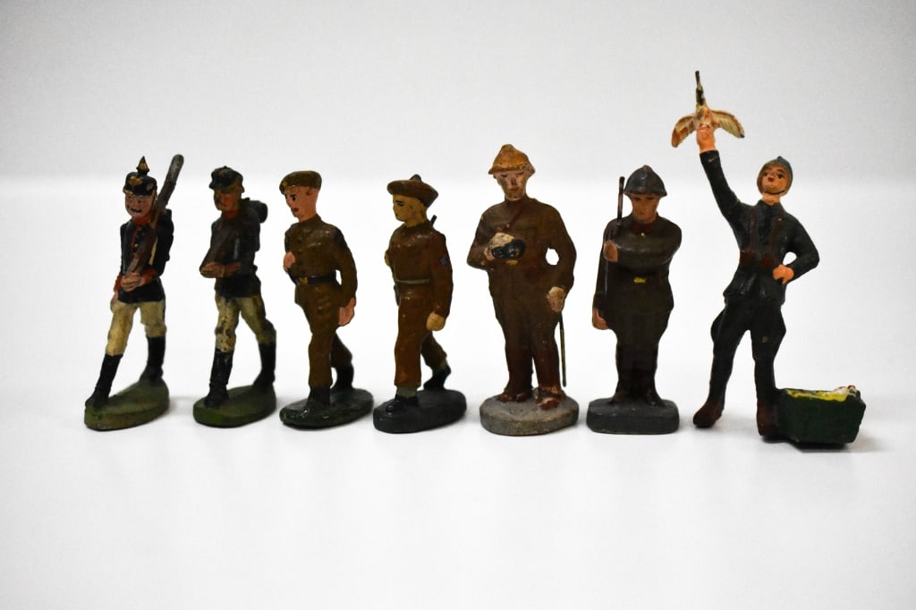 7 Composition Soldiers: No markings on them. The pigeon keeper is a interesting pose. He is roughly 3 inches tall from top of helmet to his toes. Issues can be age cracks, paint loss, damage to rifles, and overall general we