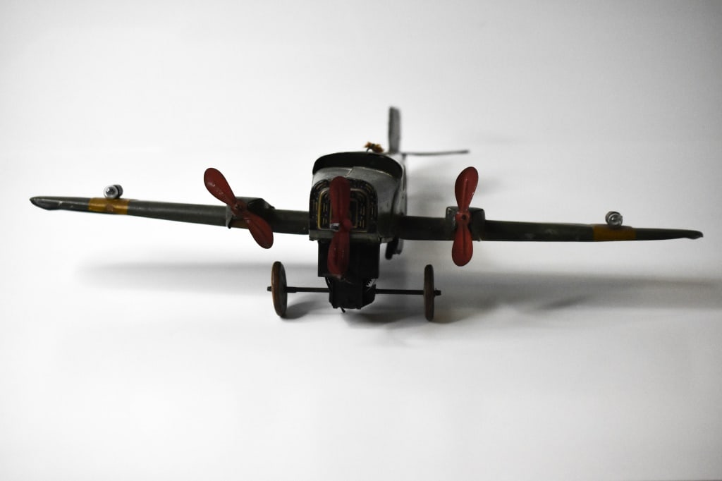 Tippco German Tin Windup Bomber Transport Airplane: Still has the swastika on the wings. Wingspan is roughly 21 inches. Key wind works but i wound it up on the table. Propeller didn't want to spin. As soon as I lifted it off the table it spun like craz