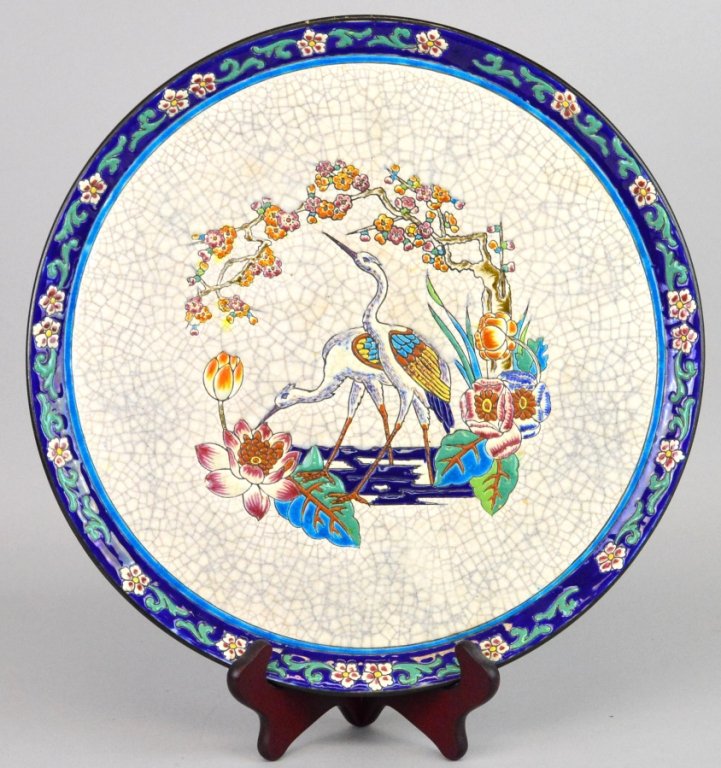 Longwy French Faience Charger: upswept floral molded rim centering incised nature scene in the aesthetic taste, marked: Longwy, D.200. Dia.14”, signed.