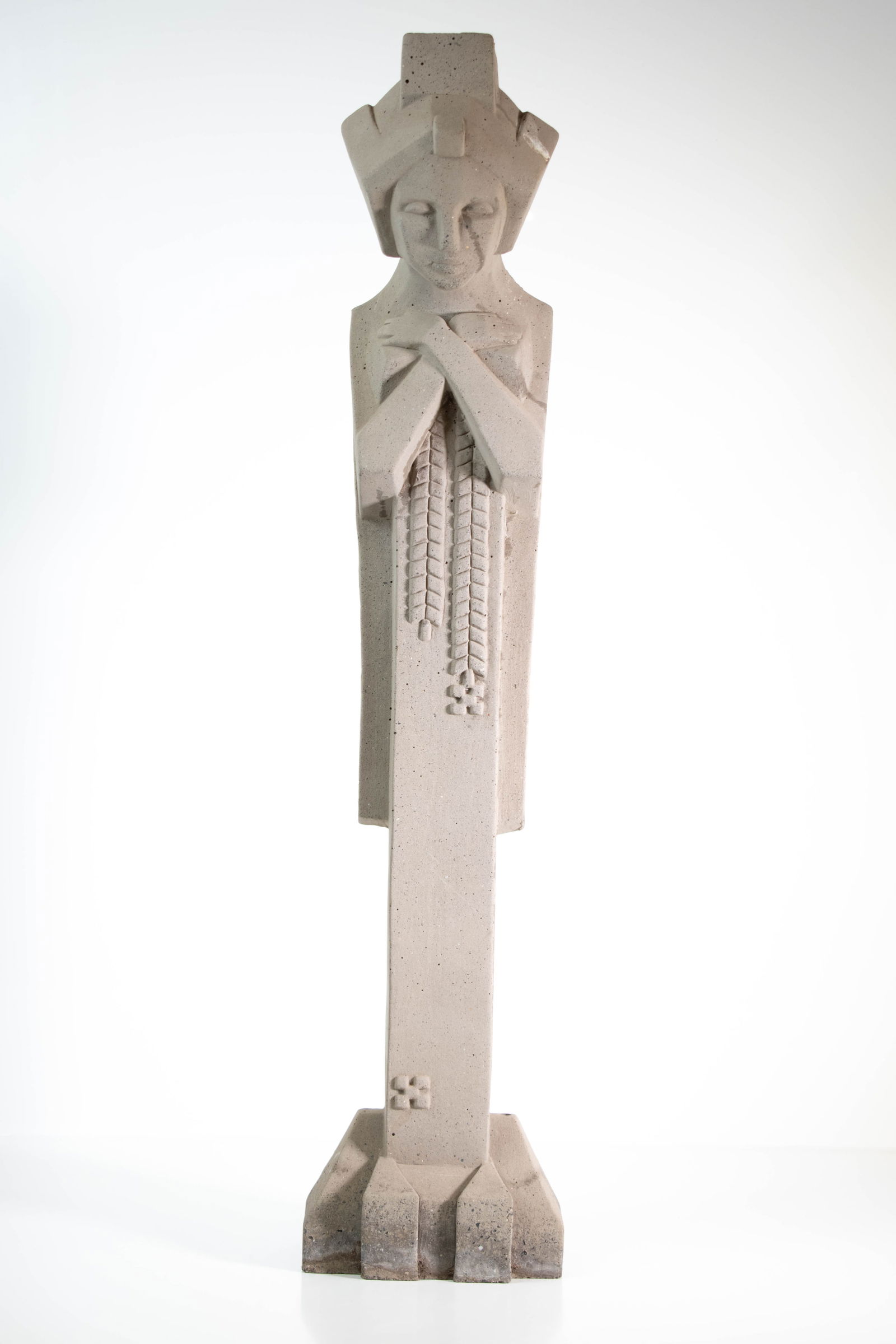 Frank Lloyd Wright Sprite Caryatid Cast Sculpture: A tall sculptural figure designed by Frank Lloyd Wright in cast stone or concrete or pale concrete material, presented in a simplified, geometric style. The figure is shown standing upright with