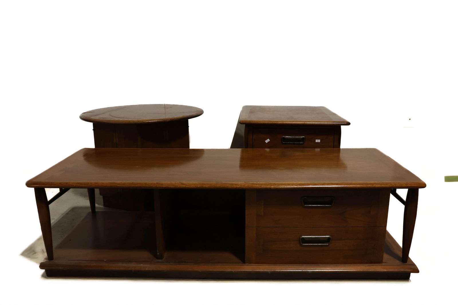 Lane Mid century modern tables: A very nice set of lane mid-century modern tables. Dovetailed decorations on top. Coffee table measures approximately 56 in long and each end table measures 20 and 1/4 in tall Stoke on Trent, England