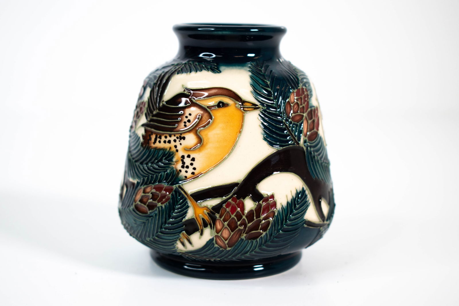 Moorcroft Art Pottery Vase 2011 Vicky Lovatt: Moorcroft art Pottery small vase in bird and pine tree pattern against cream and deep blue ground by Vicky Lovatt. Stamped to base with signature. Measuring approximately 8.5cm tall. Stoke on Trent,