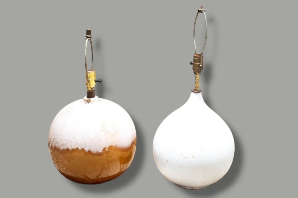 Mid Century Modern Table Lamps: Pair of Modernist Ceramic Globe Table Lamps A pair of modernist ceramic table lamps with generous globe forms and simple, sculptural profiles. One lamp features a warm brown glaze with a soft white dr