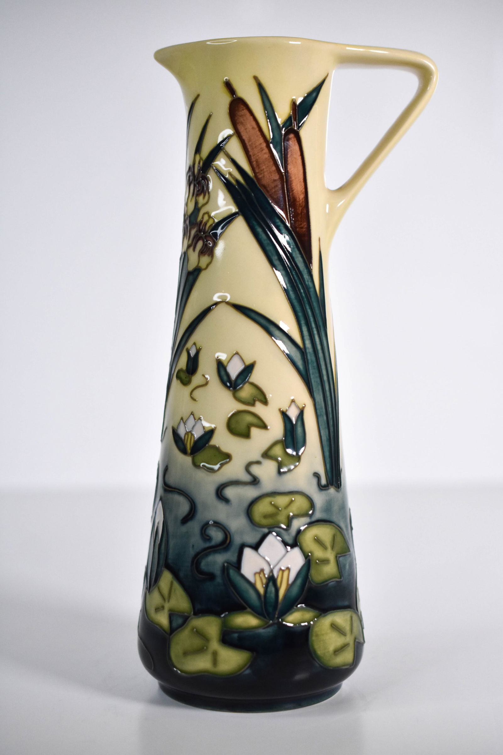 Moorcroft “Lamina?? Jug by Rachel Bishop 1995: "A striking Moorcroft pottery jug in the “Lamina” pattern, designed by Rachel Bishop. The piece features a tranquil water scene with water lilies and bullrushes, beautifully executed in