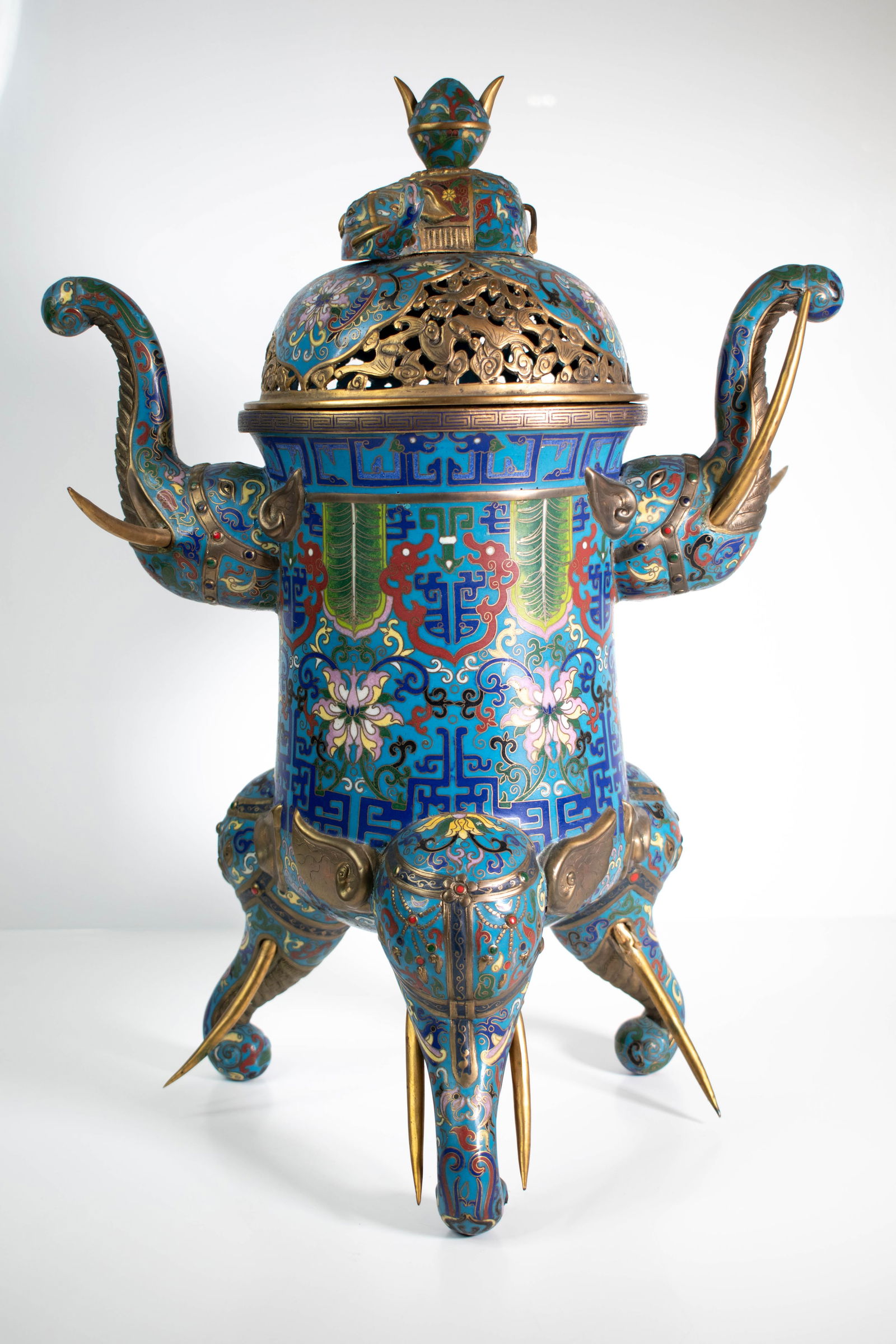 Antique Cloisonne Enameled Elephant Form Vessel: Chinese Cloisonne Censer or Vessel. A striking metal vessel formed as a stylized elephant, finished in vivid blue enamel with dense, decorative patterning throughout. The body is richly adorned with s