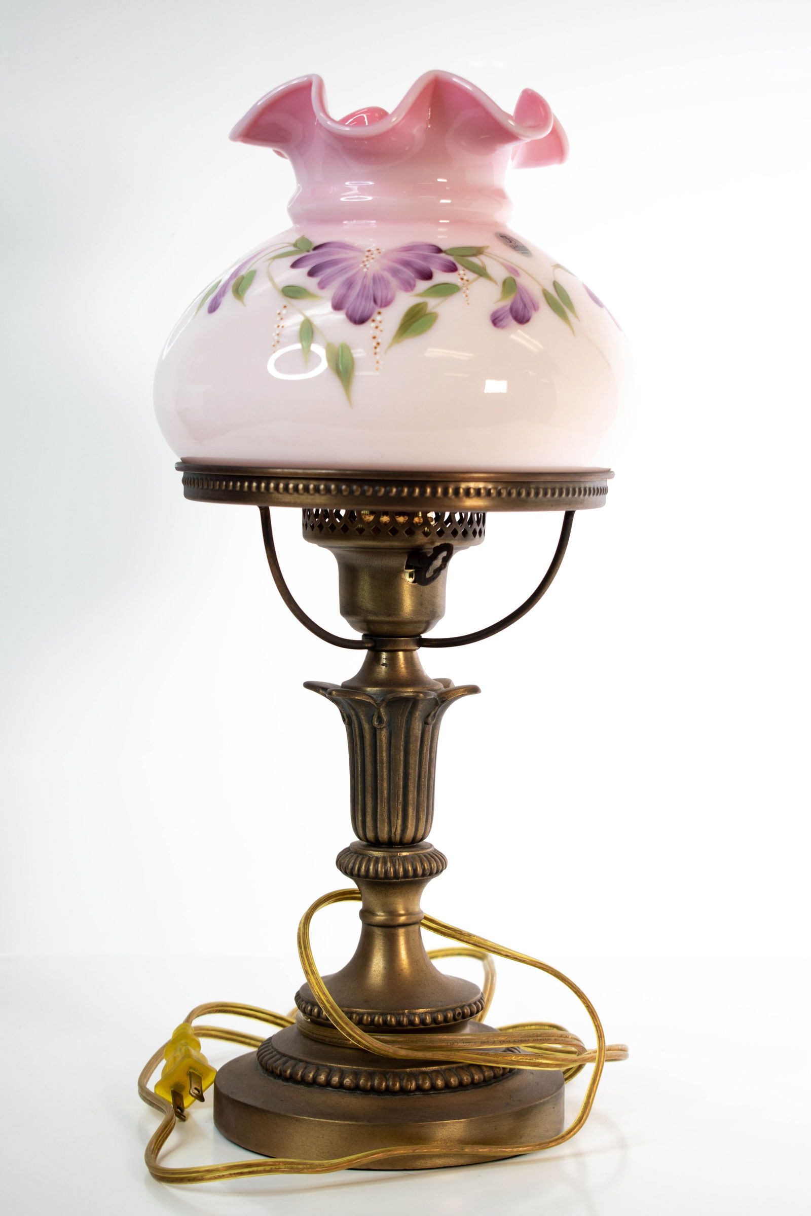 Fenton Hand-Painted Lamp (Signed & Numbered): Fenton Hand-Painted Glass Vase — Pink with Ruffled Rim and Purple Floral Design A charming Fenton Art Glass vase, hand-painted in soft pink with a delicately ruffled rim. The rounded body is beautif