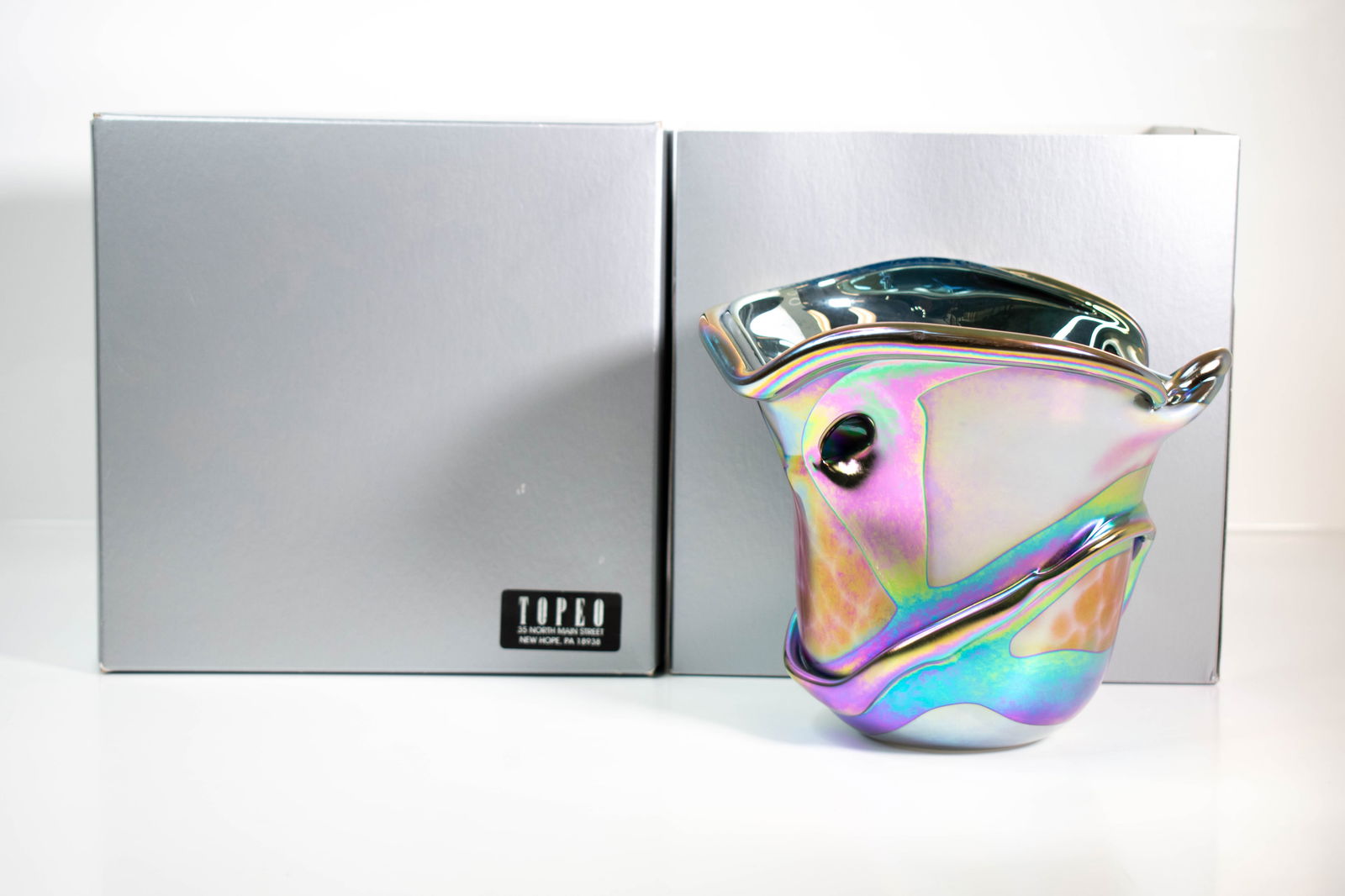 Charles Lotton Iridescant Art Glass Vase (Signed): Offered is a magnificent studio art glass vase by Charles Lotton from Topeo, presented with its original branded box, as shown. The vase features a freeform sculptural shape with an asymmetrical rim a