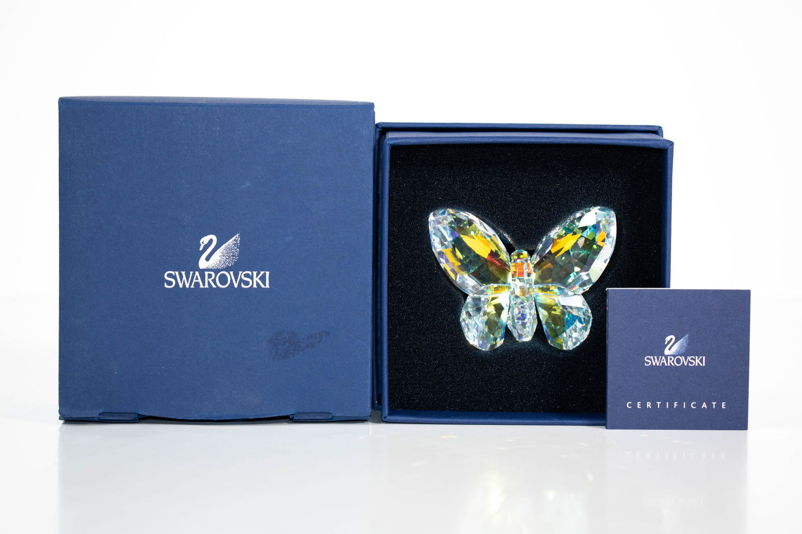 Swarovski Aurora Borealis Butterfly Figurine: This Swarovski butterfly figurine is crafted in clear crystal with an iridescent Aurora Borealis finish that shifts through soft blues, greens, pinks, and gold tones as the light moves. Precision-cut