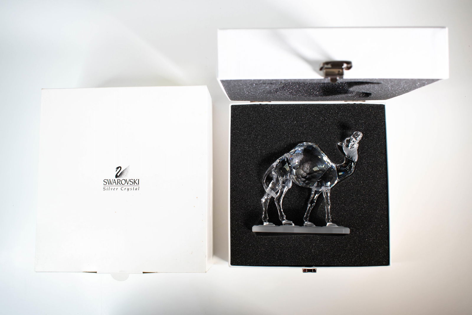 SWAROVSKI CAMEL 247683: This retired Swarovski crystal camel was part of the “African Wildlife” family group. A member of the Dromedary family, it only has one hump. The body of the piece is made from clear crystal w