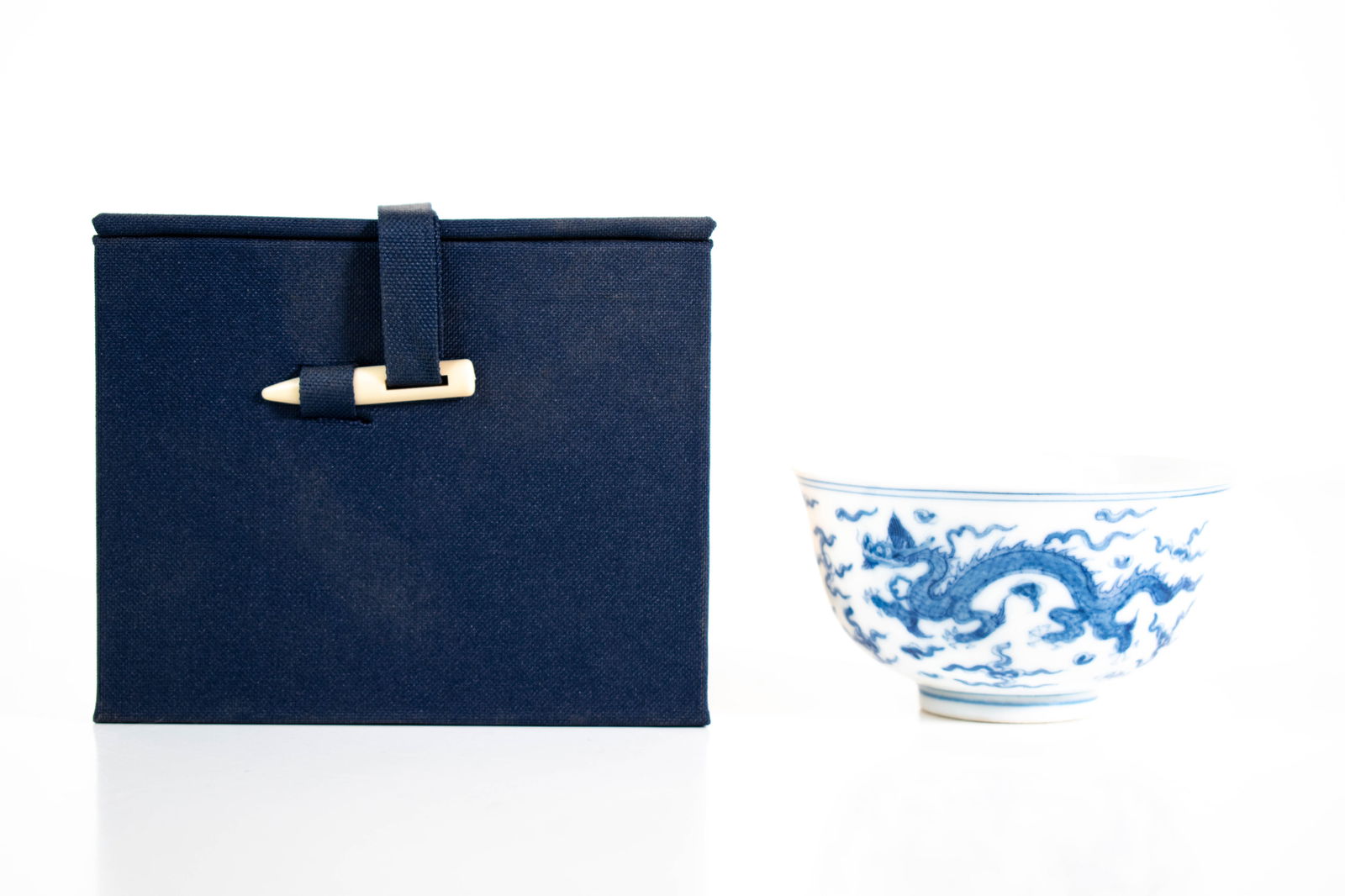 Chinese Porcelain Cup with Dragon (Signed): A fine Chinese blue and white porcelain cup. It is decorated with dragon and clouds. The base with a Ming Dynasty six character mark. Length 3" ****We Offer In-House Shipping***