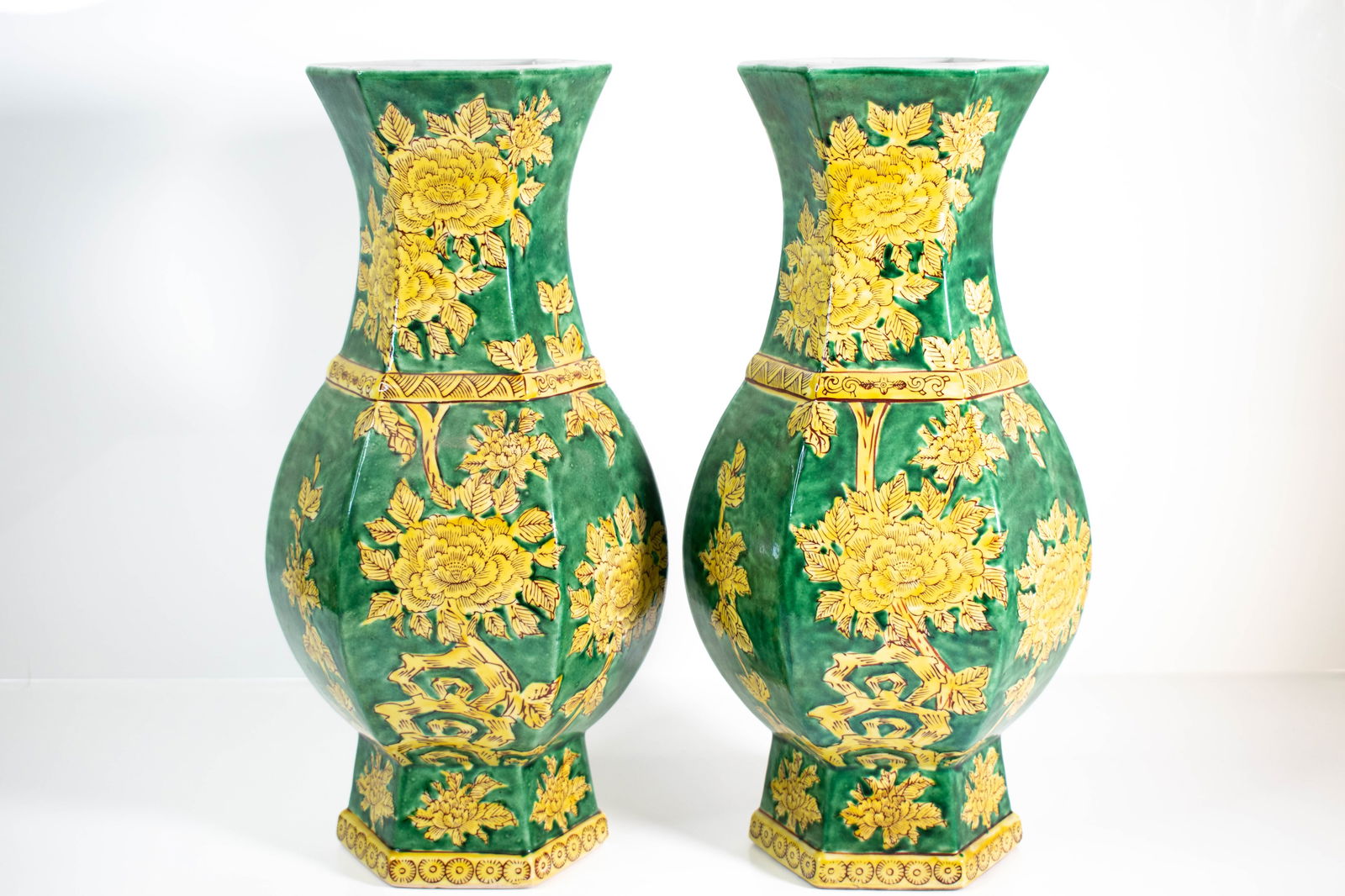 Chinese Porcelain Vases: A fine pair of hexagonal style Vases with yellow or gold flowers on a green background. Height 15.5" ****We Offer In-House Shipping***