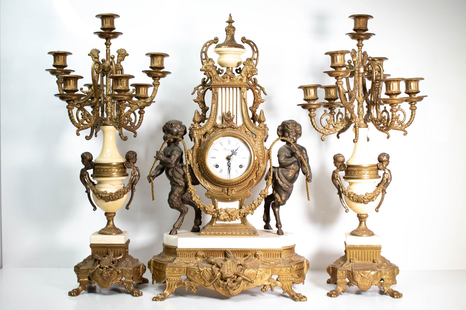Ornate Italian Satyr Bronze Clock & Garnitures: A large Italian Bronze and marble clock and garnitures. Very Ornate. Decorated with Faun or satyr and other motifs. Largest item Height 25" ****We Offer In-House Shipping***