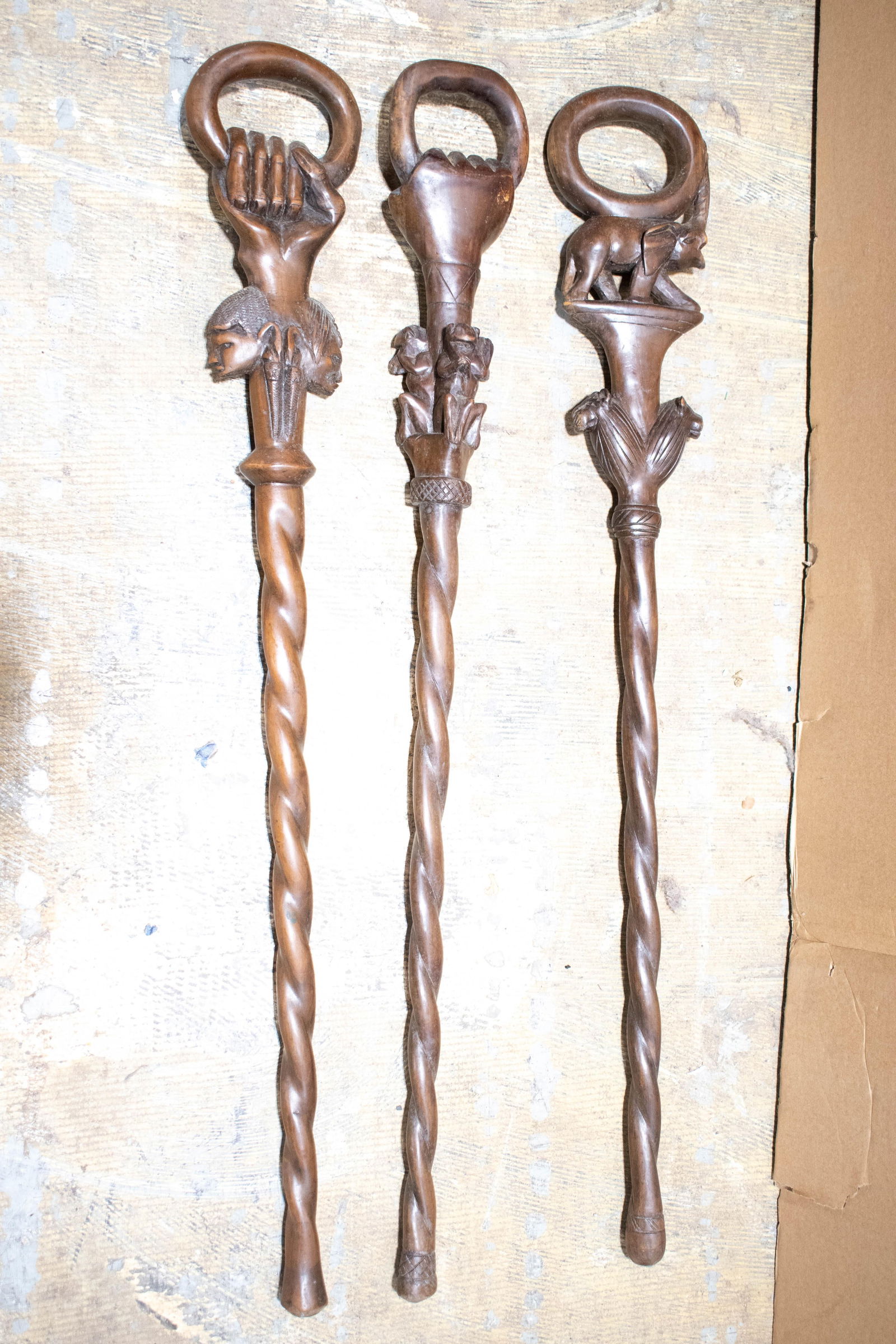 Hand Carved African Walking Sticks: (3) carved canes or walking sticks, wear commensurate with age and use; no noticeable chips, cracks, or breaks. All measures approx. 36"h.