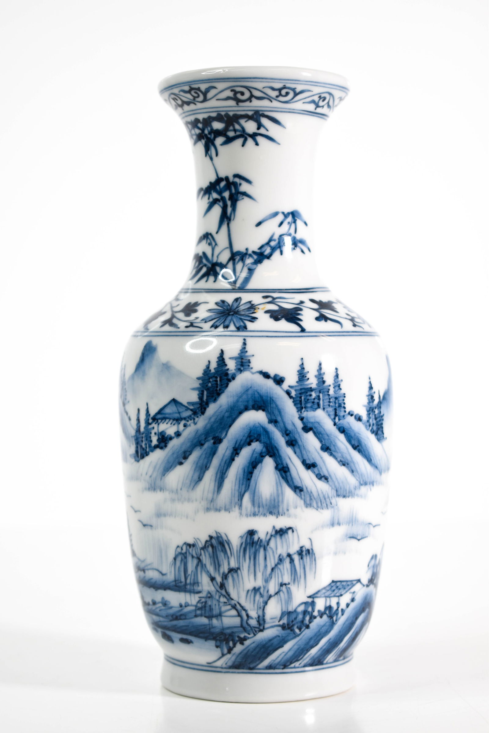 Chinese Blue and White Vase: A fine Chinese Porcelain vase. The underside with two concentric rings and a apocryphal six character seal mark. Height 8" ****We Offer In-House Shipping***