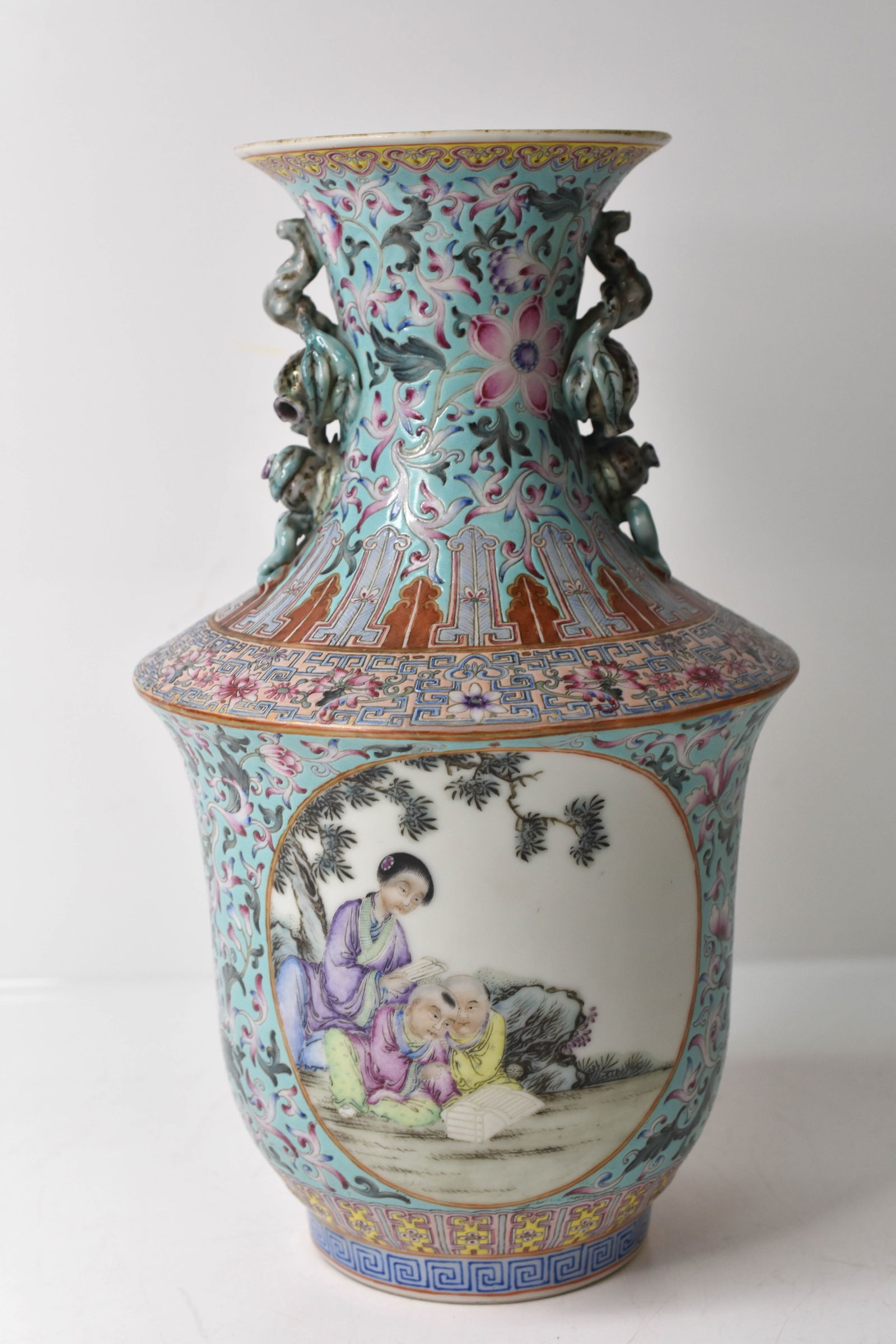 Chinese Porcelain Vase Circa 1900-1910: Includes a signed (the mark well done and in good form and balance). Republic of China porcelain vase, made in the Qing Dynasty style, molded and enameled Famille Rose style on a blue ground,
