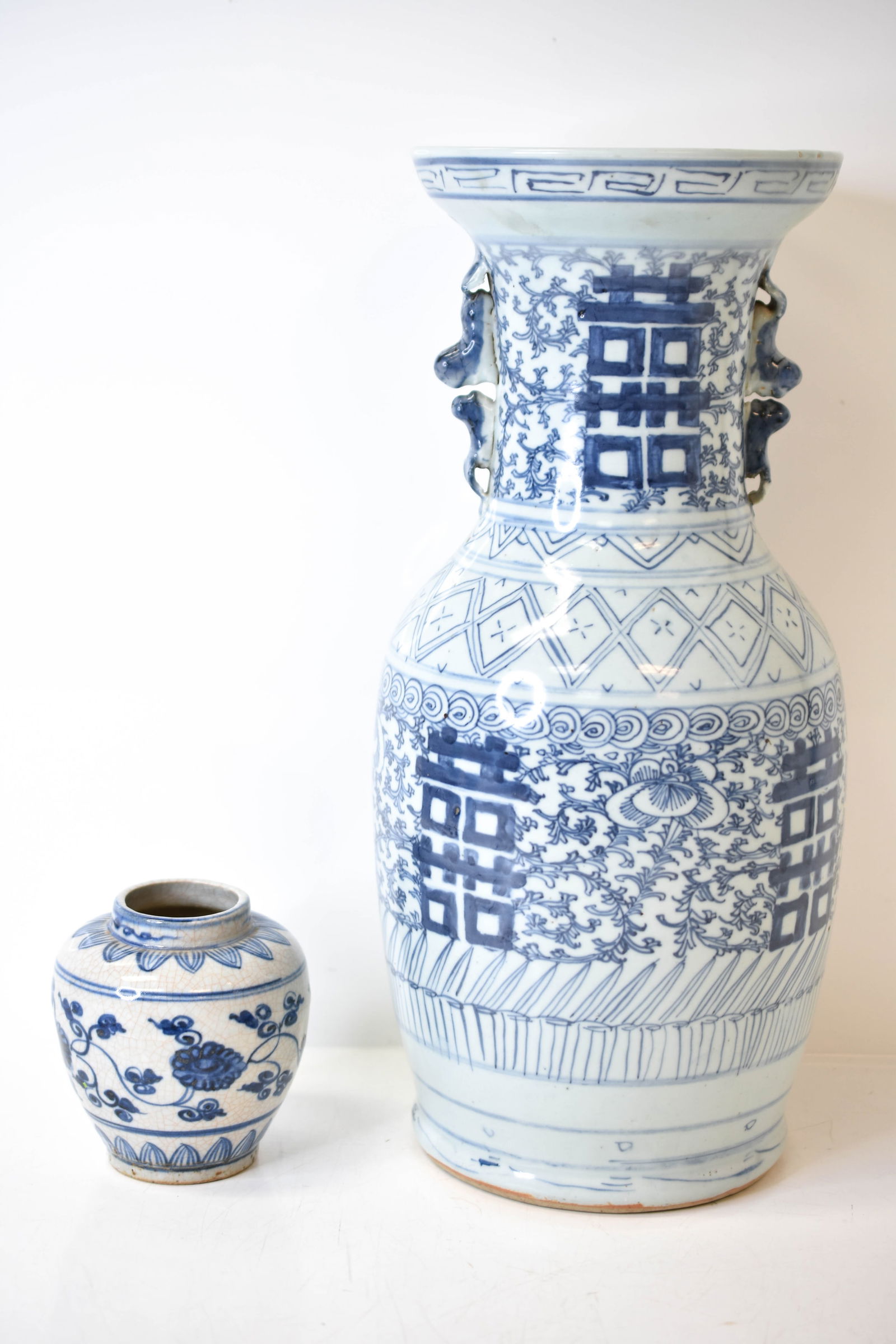 Chinese Export Blue & White Vases: Includes a pair of Chinese porcelain vases or vase and a jar, the larger vase appears to be in clean condition. Smaller vase was repaired, as seen in pictures. Largest piece measures approx. 17"h