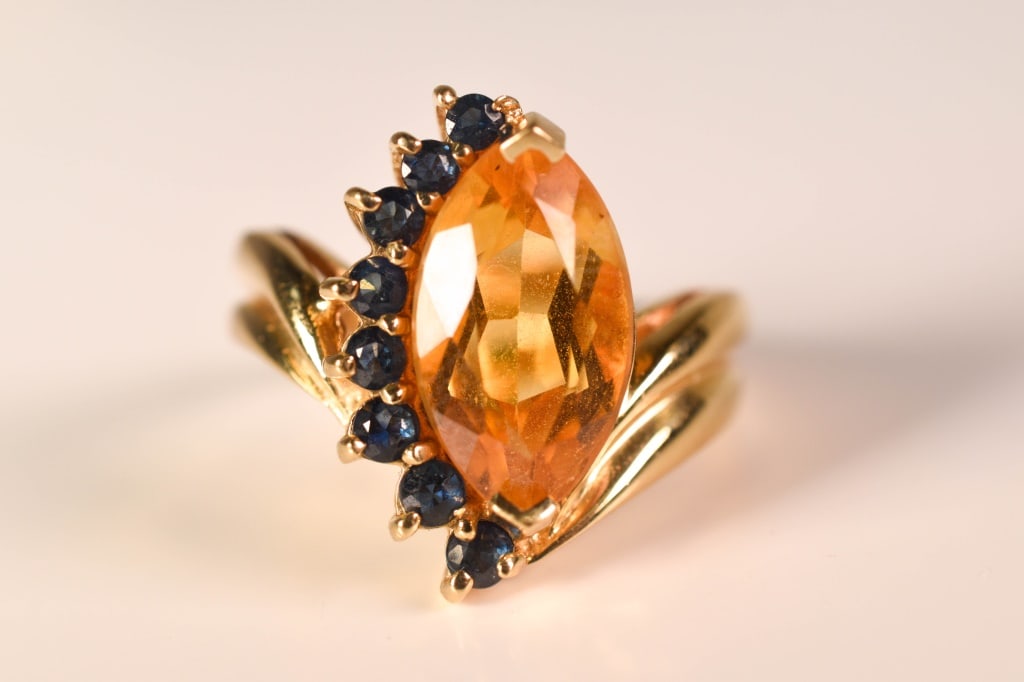 14K Gold Citrine & Sapphire Ring 6.4 Grams: Marquise cut citrine apx. 14mm x 8mm x 5mm; 8 graduated round cut blue sapphires ranging from 2mm to 2.5mmSize: 8