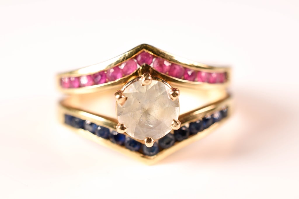14K Gold, Rubies, Sapphires, Diamond Simulant Ring: Diamond imitation flanked by 13 rubies and 13 blue sapphires, each apx. 1.5 mm diameter, weighs approx. 4.3 Grams