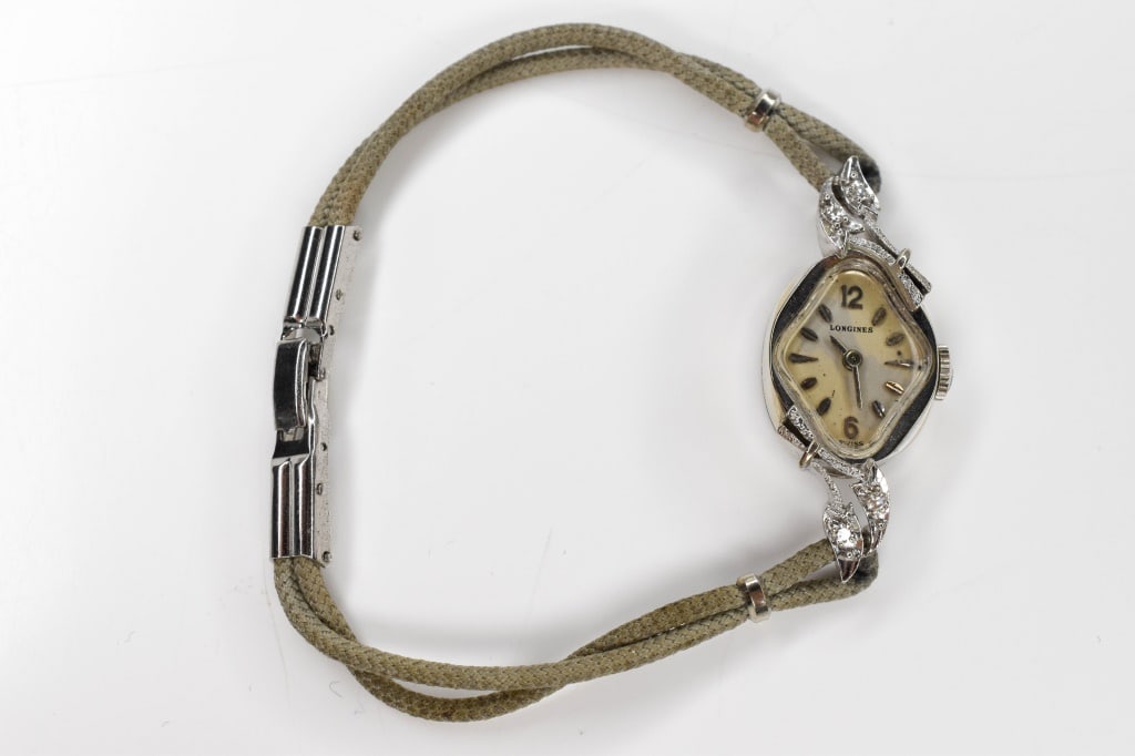 14K Gold Diamond Longines Ladies Watch: gray cord band, case contains 4 single cut diamond accents