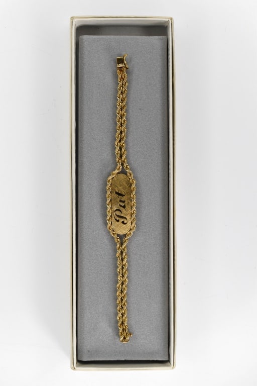 14K Gold Rope Chain Bracelet: 14K yellow gold double rope chain with center plaque with "Pat" cut-out, 6.5" length, 11.72 dwt. Housed in a Freeman Jewelers box and felt Reference #18