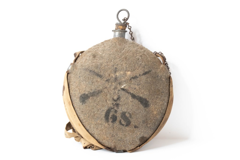 Spanish American War US Army Canteen: Cover has loss as seen in photos. appears to be for 68th Infantry Regiment. Corkscrew stopper is broken in 2. Staining in areas. Part of the metal of the canteen is exposed at the bottom. Provenance: 