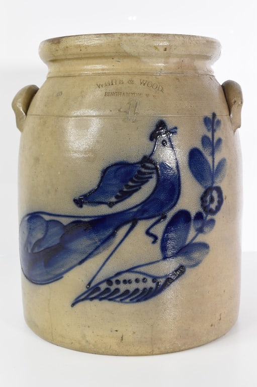 White & Wood Blue Decorated Bird 4 Gallon Crock: About 13 inches tall. Stamped white & wood Binghamton 4. Blue decoration is nice and bright. Below the tail is a 3 inch hairline. Right of the blue Decorated ball of the flower is a chip. Almost