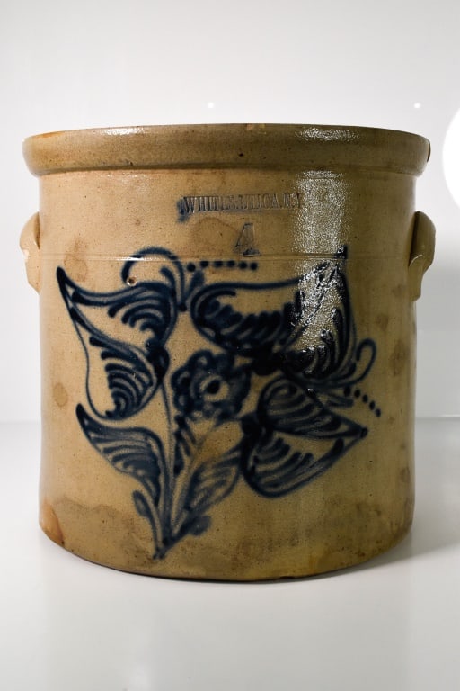 Whites Utica Stoneware Blue Decorated Crock: 4 Gallon; About 11 inches tall. Chips on the top rim. Stamped Whites Utica NY 4. Floral blue decoration. There is a bubble burst hole in the floral decoration top left center. Discoloration in areas.