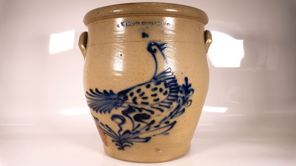 W Roberts Blue Decorated Bird Stoneware Crock: Stamped W Roberts Binghamton NY. Slight flake in the birds head. Edge roughness on the top rim. Crazing on the handles. Bottom edge has multiple chips. Below the birds chest is a large flake or chips.