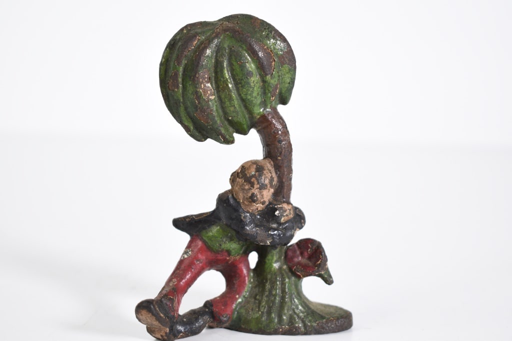 John Wright Cast Iron Bottle Opener: Drunk hanging on a palm tree. Paint loss. Some surface rust. 4 inches tall. Provenance: Acquired from a single owner private estate collection originating in Gettysburg, Pennsylvania. The collection w