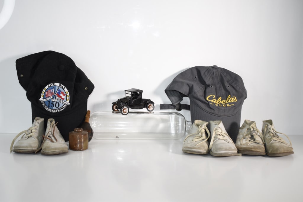 Baby Shoes Hats & Others Tray Lot: capella and Civil War anniversary hat. Glass19 inch rolling pin. Wooden sick dorner. Stoneware inkwell. 3 pairs of baby shoes. All have wear from use and storage. Provenance: Acquired from a single ow