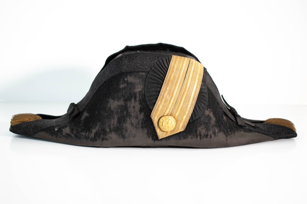 1800s US Navy Fore & Aft Bicorne: Fur covering is missing in many areas. Hard to read the maker but they are from Annapolis MD. Tried to look underneath the sweatband. But it felt brittle so we left it alone. Size is not given. Overal
