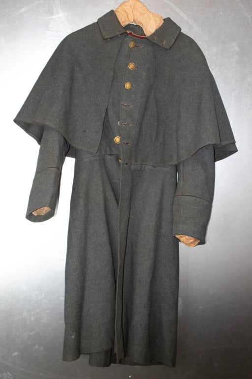 1800s New York National Guard Overcoat: 7 buttons down the front. 2 Collar buttons. 1 is a post Civil US army button. Moth tracking and nips all over. Has a pocket in the front for a pocket watch. No interior pockets. Size is not given. Fro