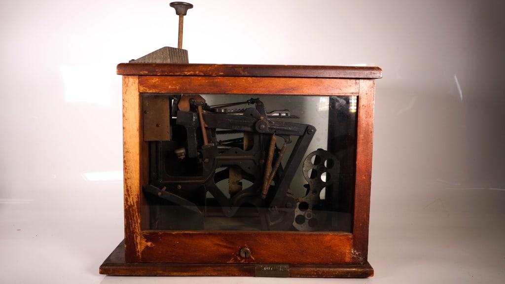 Antique Midland Supply Co. Duplex Stamp Machine: Wooden body with glass sides. wear to the wooden cabinet. Cabinet is 8.25 x 11.5 x 15 inches. Provenance: Acquired from a single owner private estate collection originating in Gettysburg, Pennsylvania