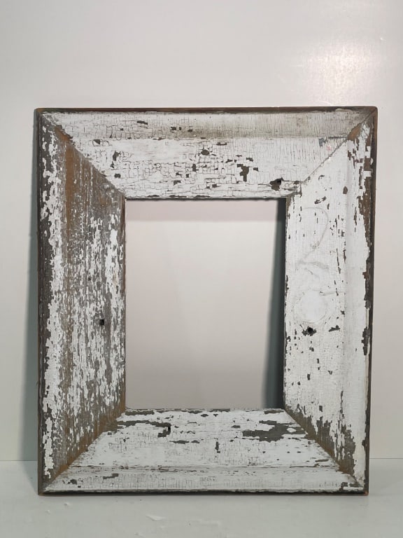 Antique Distressed White Painted Wood Frame: Wood frame with a distressed white painted finish revealing natural wood underneath. Features a rectangular opening, measuring approximately 21 inches wide by 24 inches high. Characterized by a