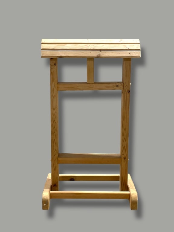 Lectern With Slanted Top: Wood lectern featuring a slanted top supported by a rectangular frame and stabilizing base. Constructed with natural-toned wood and showcasing simple craftsmanship. Measures approximately 20 W x 34