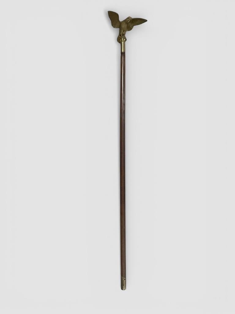 Processional Staff with Brass Eagle: Wood shaft pole featuring a detailed brass eagle head ornament at the top. The eagle design showcases outstretched wings and intricate feather details attached to a brass fitting. Total height is