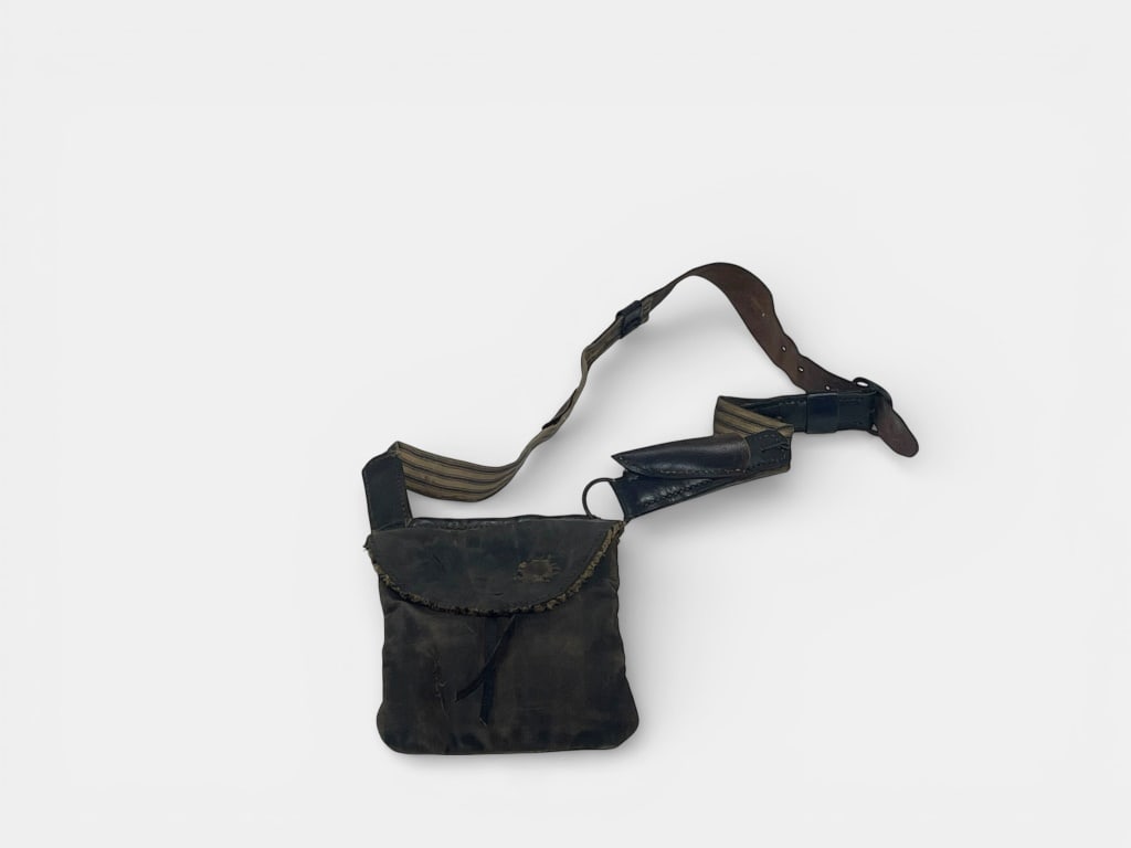 Antique Leather Bag with Canvas Strap 1800s: Leather bag featuring a flap closure and an adjustable canvas strap with leather details. The strap includes a buckle for length adjustments. Approximate height is 27 H. Notable rugged construction.