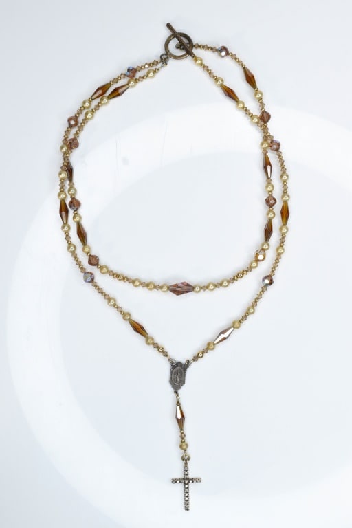 10K Gold & Diamond Cross and more: 10K Gold & Diamond Cross, sterling pendant incorporated with multi string beads of various styles of materials. Chain measures approximately 22"l.
