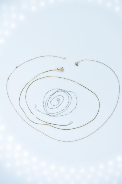 14 & 18K Jewelry 3.57g: Lot Includes 1 gold 18k gold necklace measuring approximately 11.5" in length and 2 14K Gold necklaces measuring approximately 18.5? in length. Combined weight totals approximately 3.57g.
